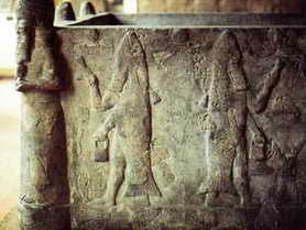 Pagan priests as half-fish sprinkling holy water